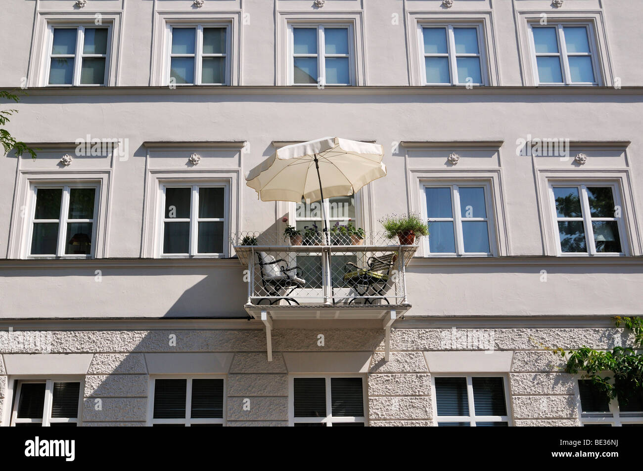Nikolaistrasse street, facade with a balcony and parasol, Schwabing, Munich, Bavaria, Germany, Europe Stock Photo