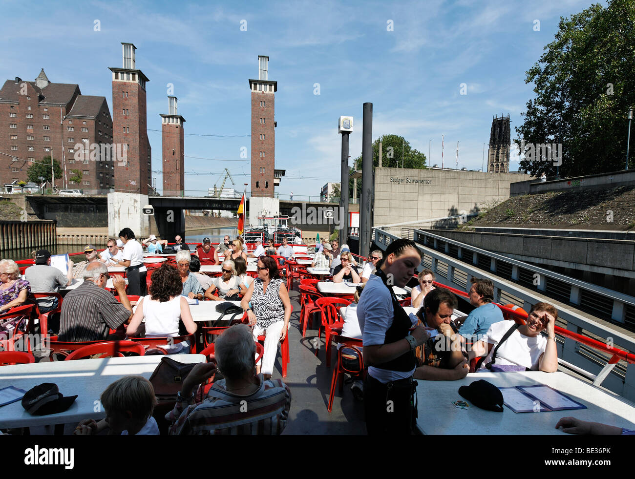 Sun deck of a cruise ship with tourists, view of the Schwanentorbruecke bridge, harbor cruise, outer harbor, Duisburg, Ruhrgebi Stock Photo