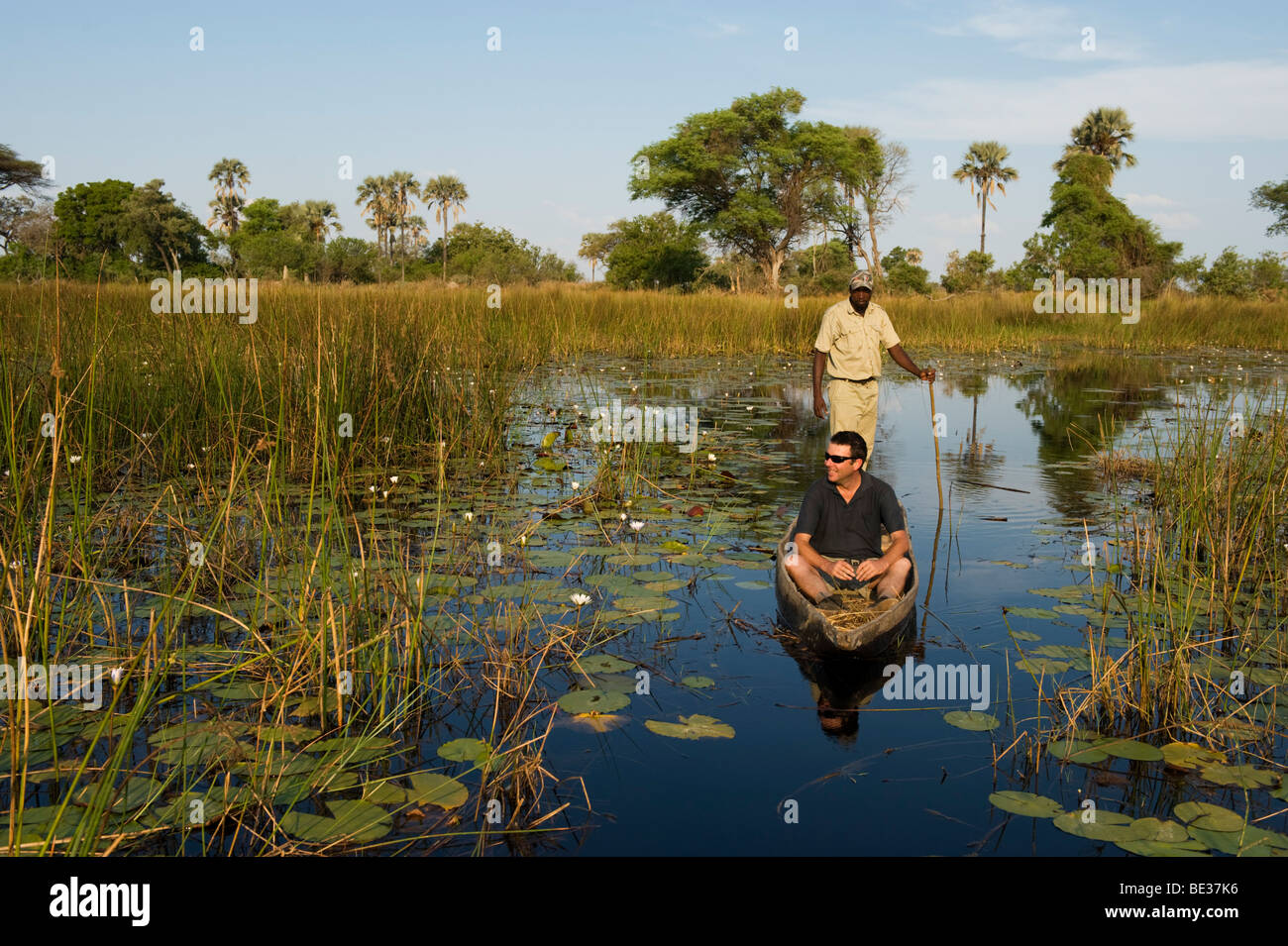 Tourist on mokoro trip, Okavango Delta, Botswana Stock Photo