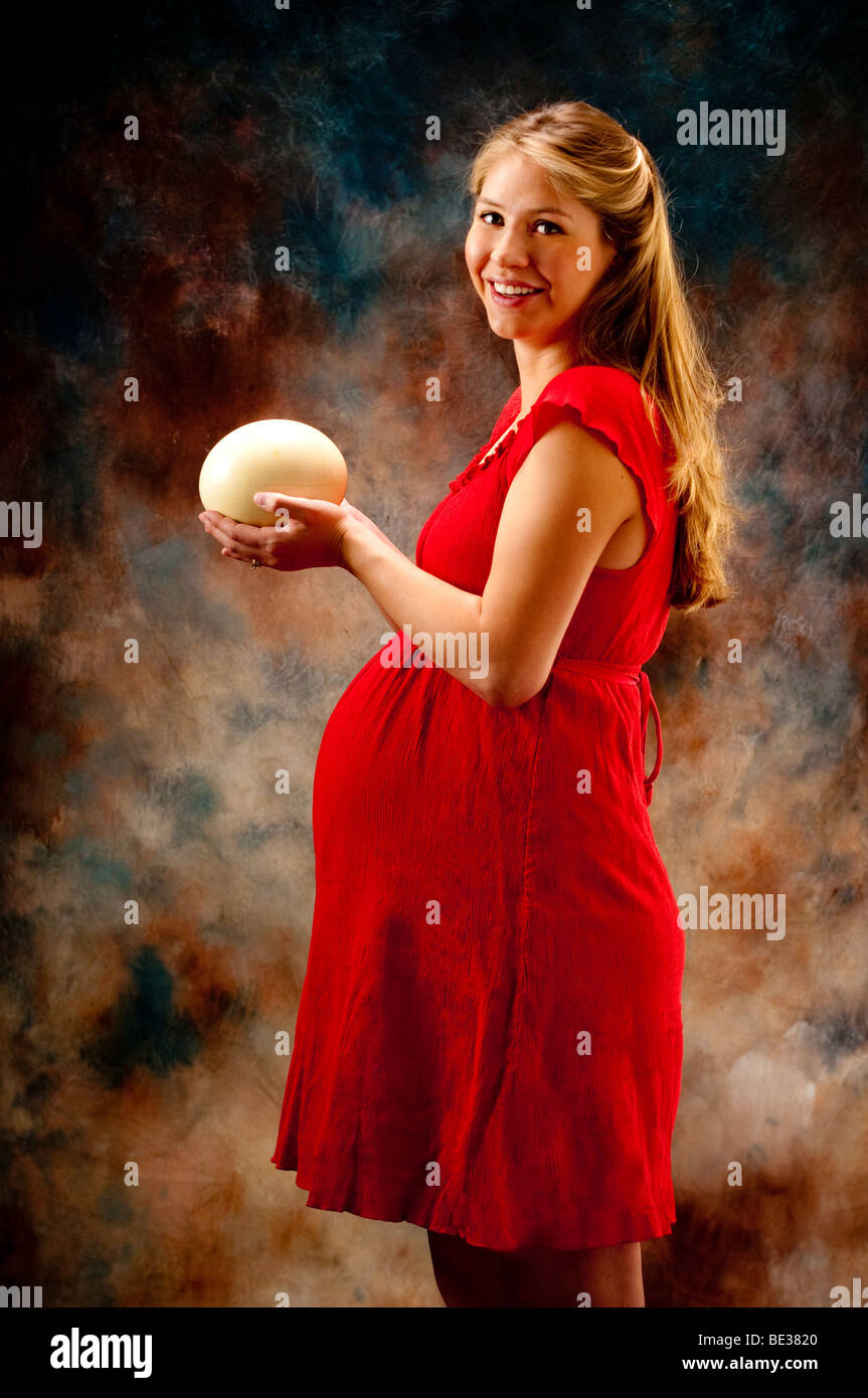 lovely pregnant woman holding large ostrich egg Stock Photo Alamy
