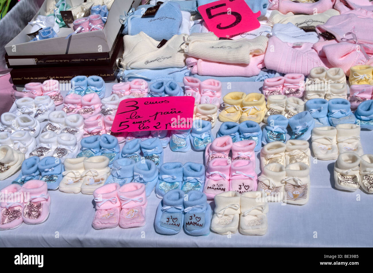 Baby shoes and baby clothes Stock Photo - Alamy