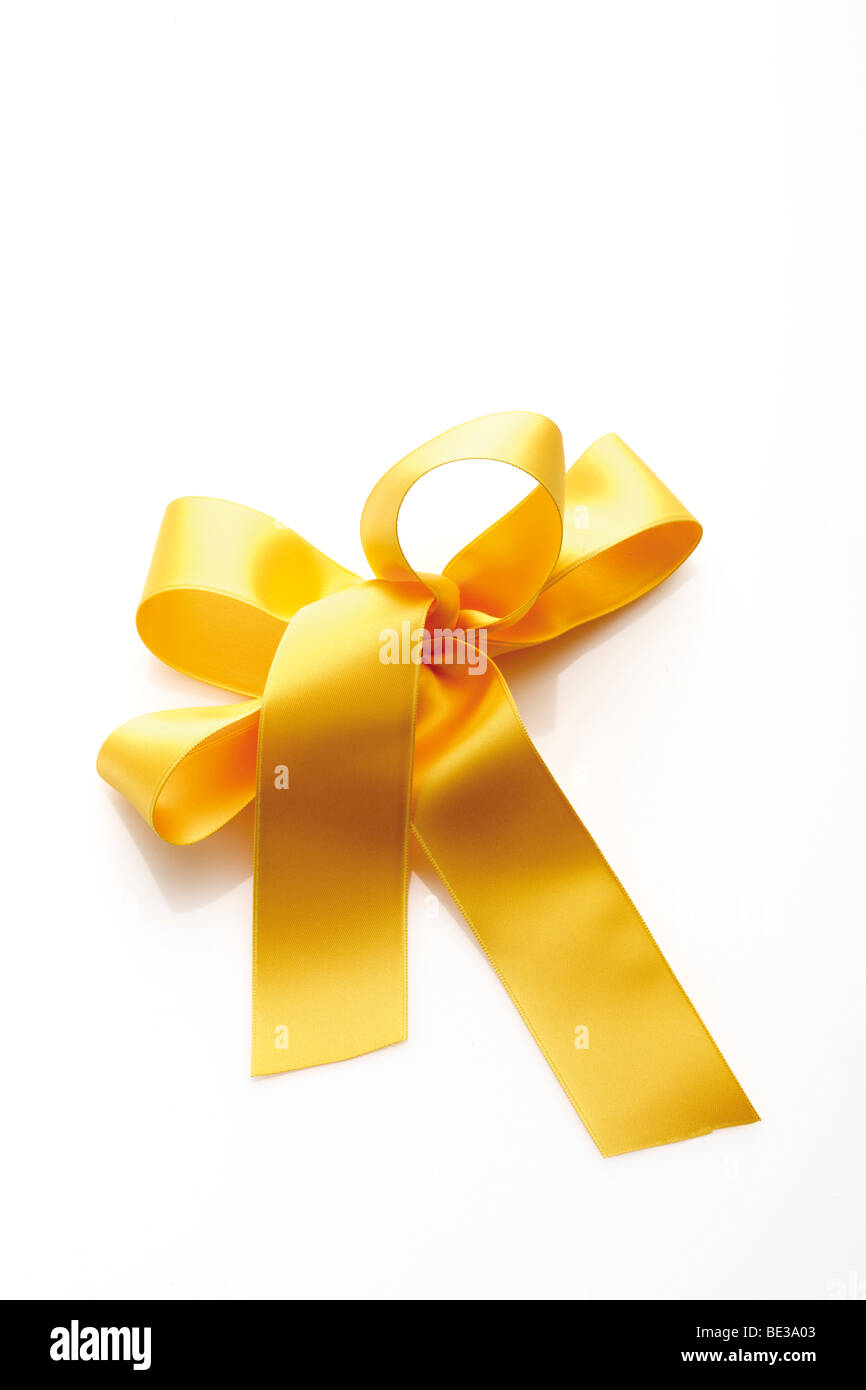 Gold yellow gift ribbon in a bow Stock Photo