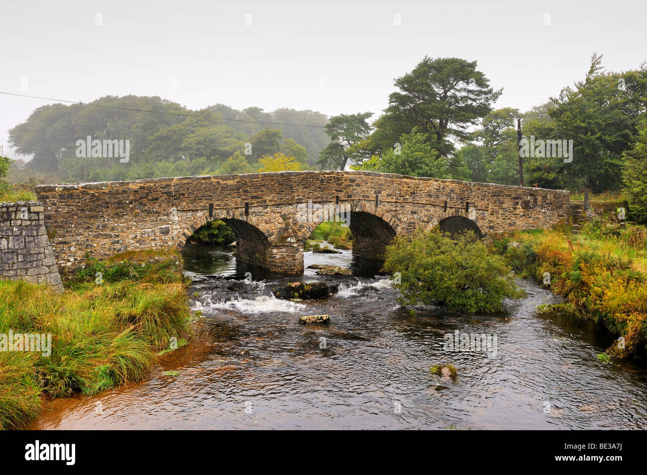 Old bridge made of granite slabs or Clapper Bridge over the Dart river, Dartmoor National Park, Devon, England, UK, Europe Stock Photo