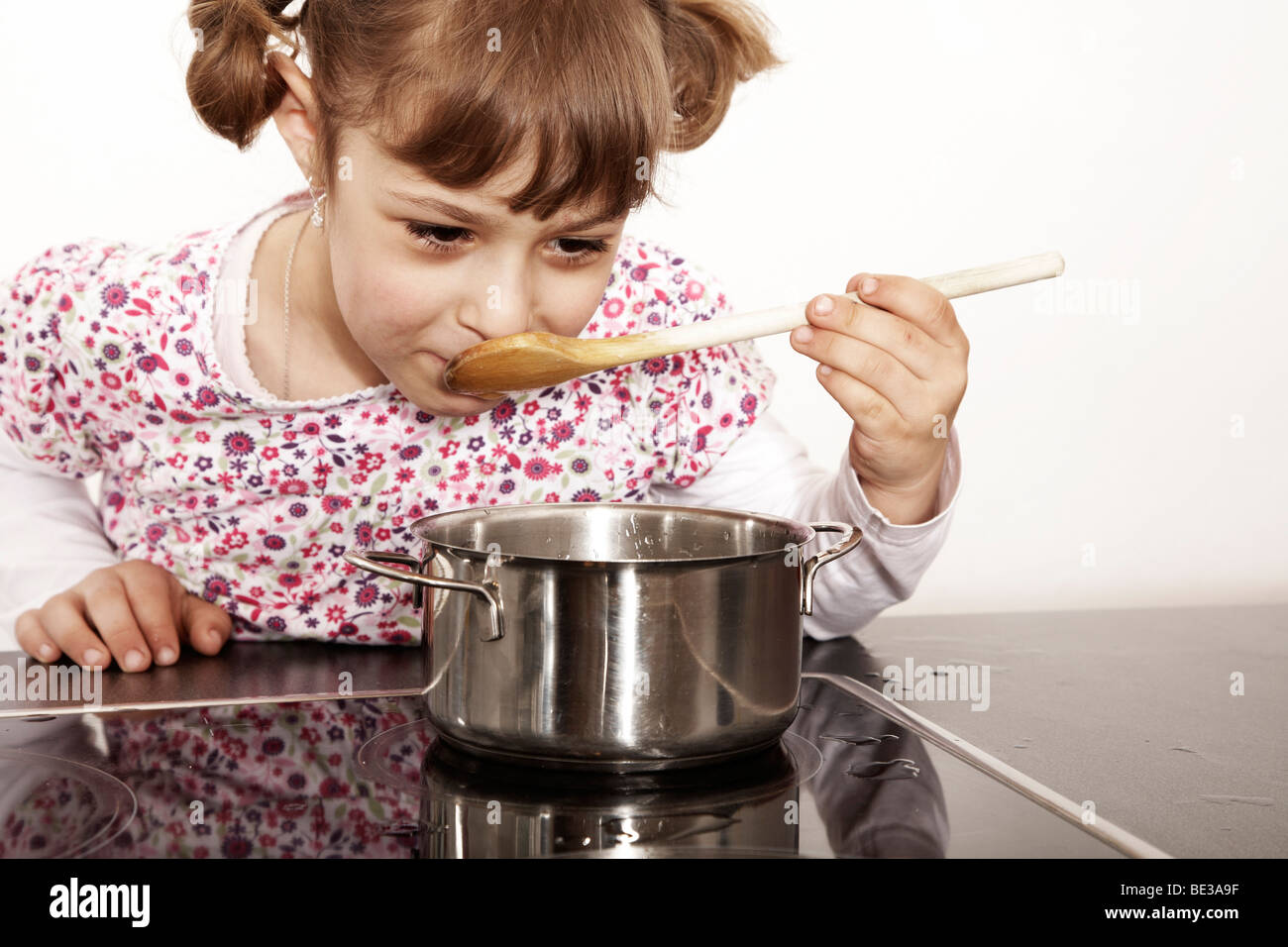 Sixyearold girl playing in the kitchen Stock Photo Alamy
