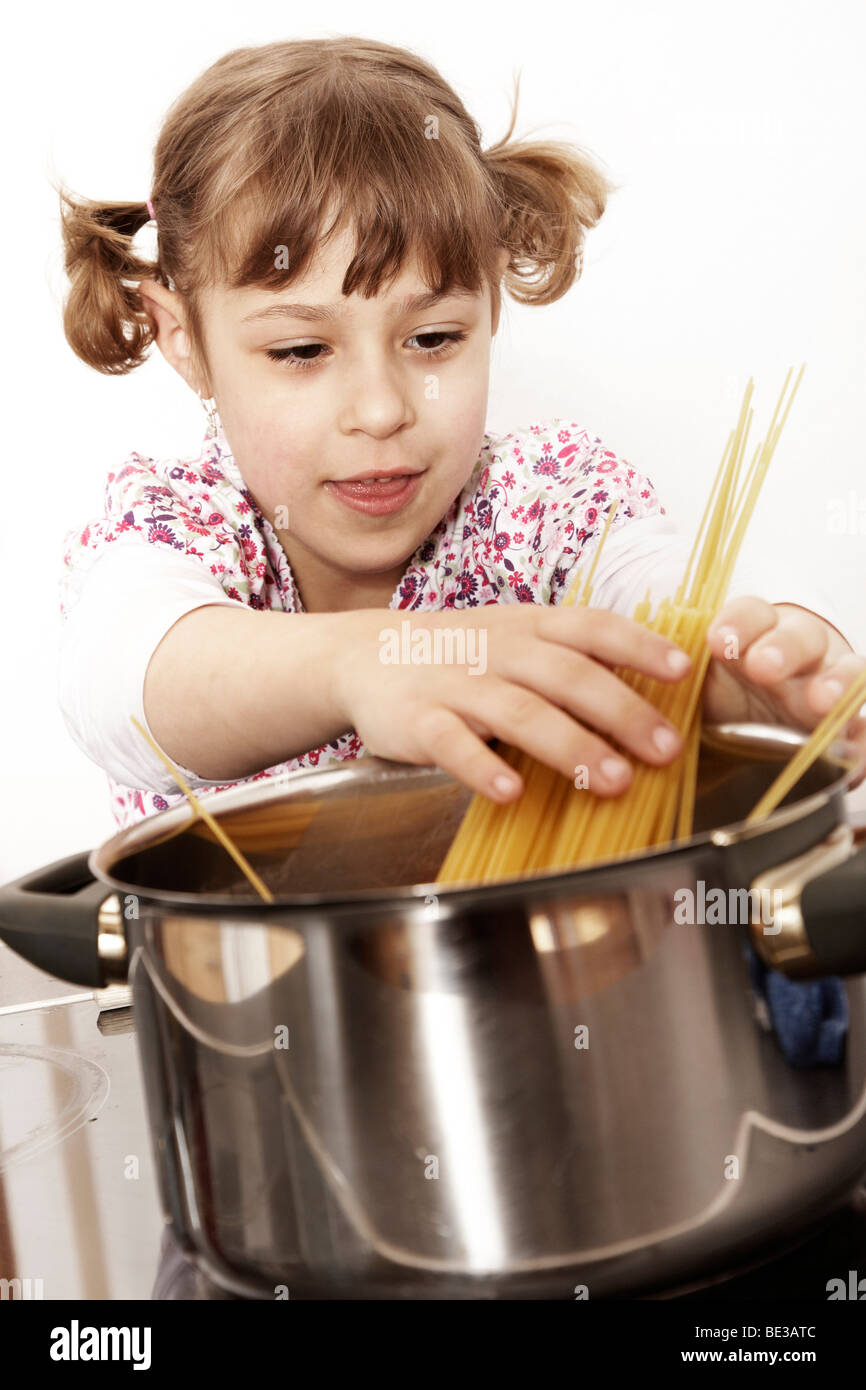 Sixyearold girl playing in the kitchen Stock Photo Alamy