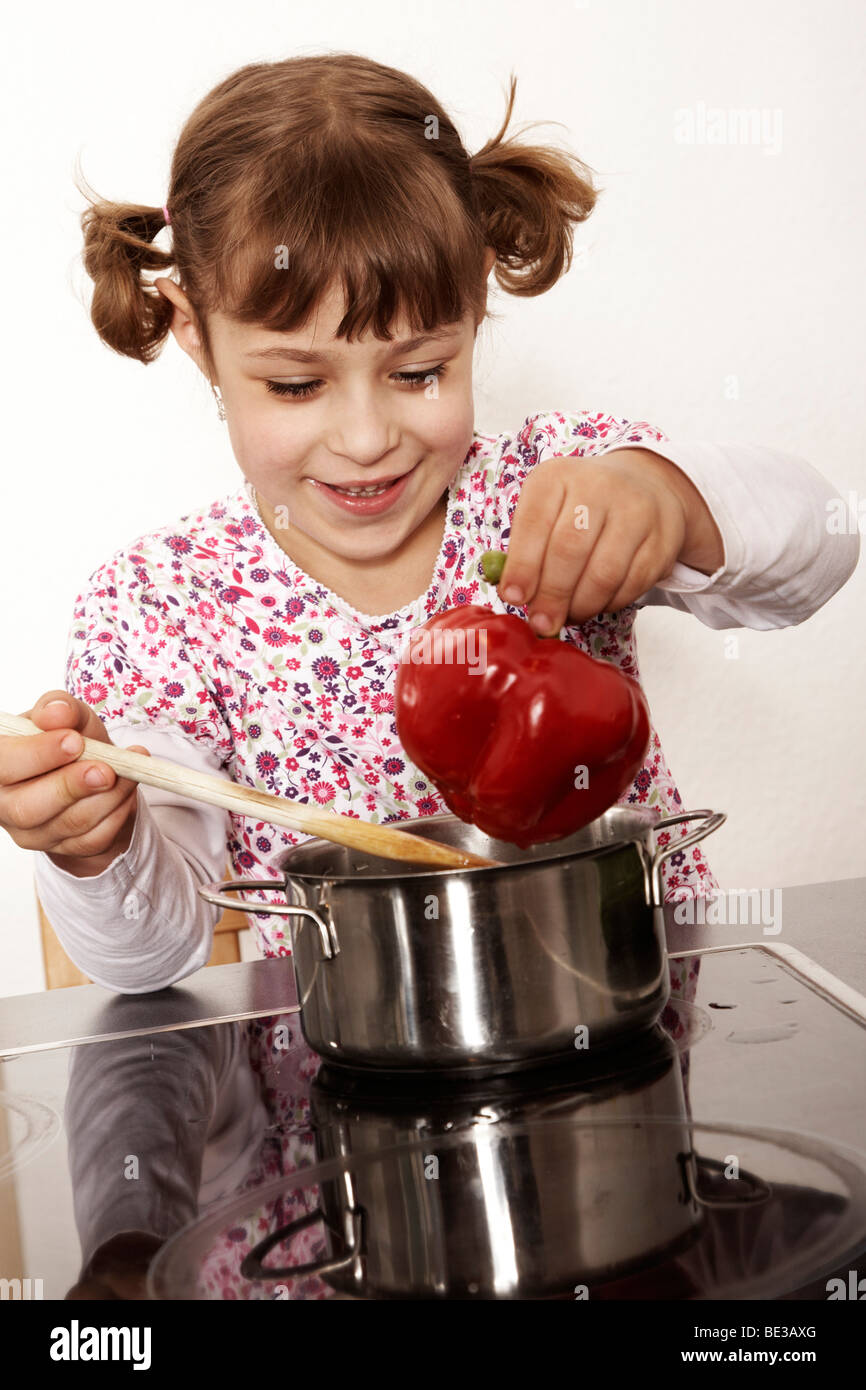 Sixyearold girl playing in the kitchen Stock Photo Alamy