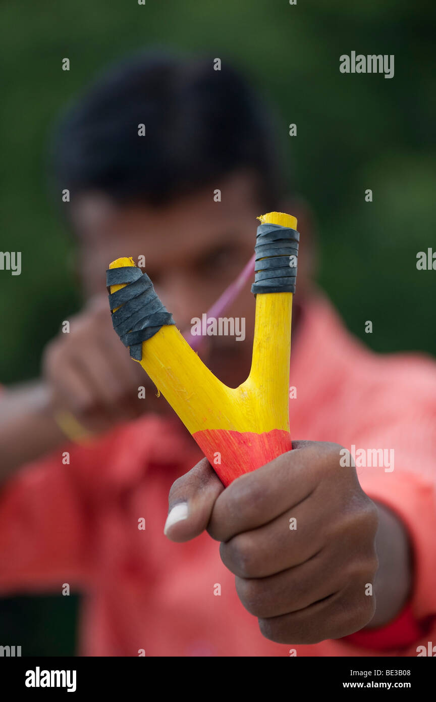 Indian man firing a catapult. India Stock Photo