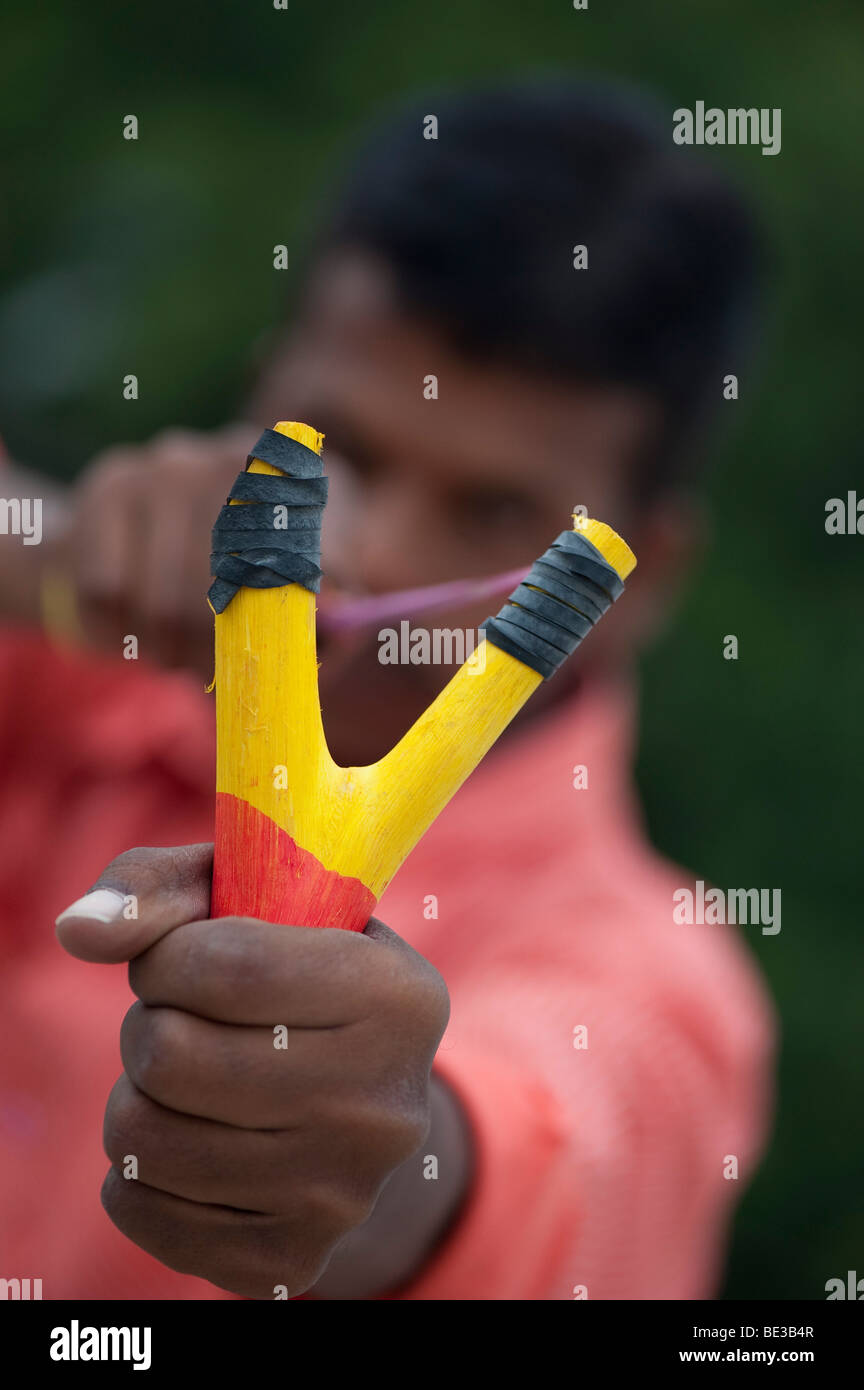 Indian man firing a catapult. India Stock Photo