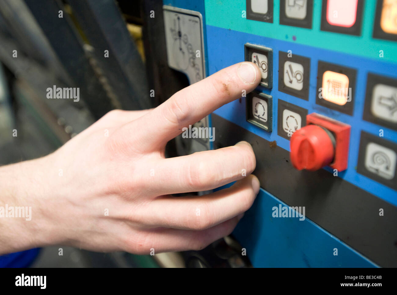 Operating the controls of a printing machine, print shop, sheetfed offset, folded box production Stock Photo