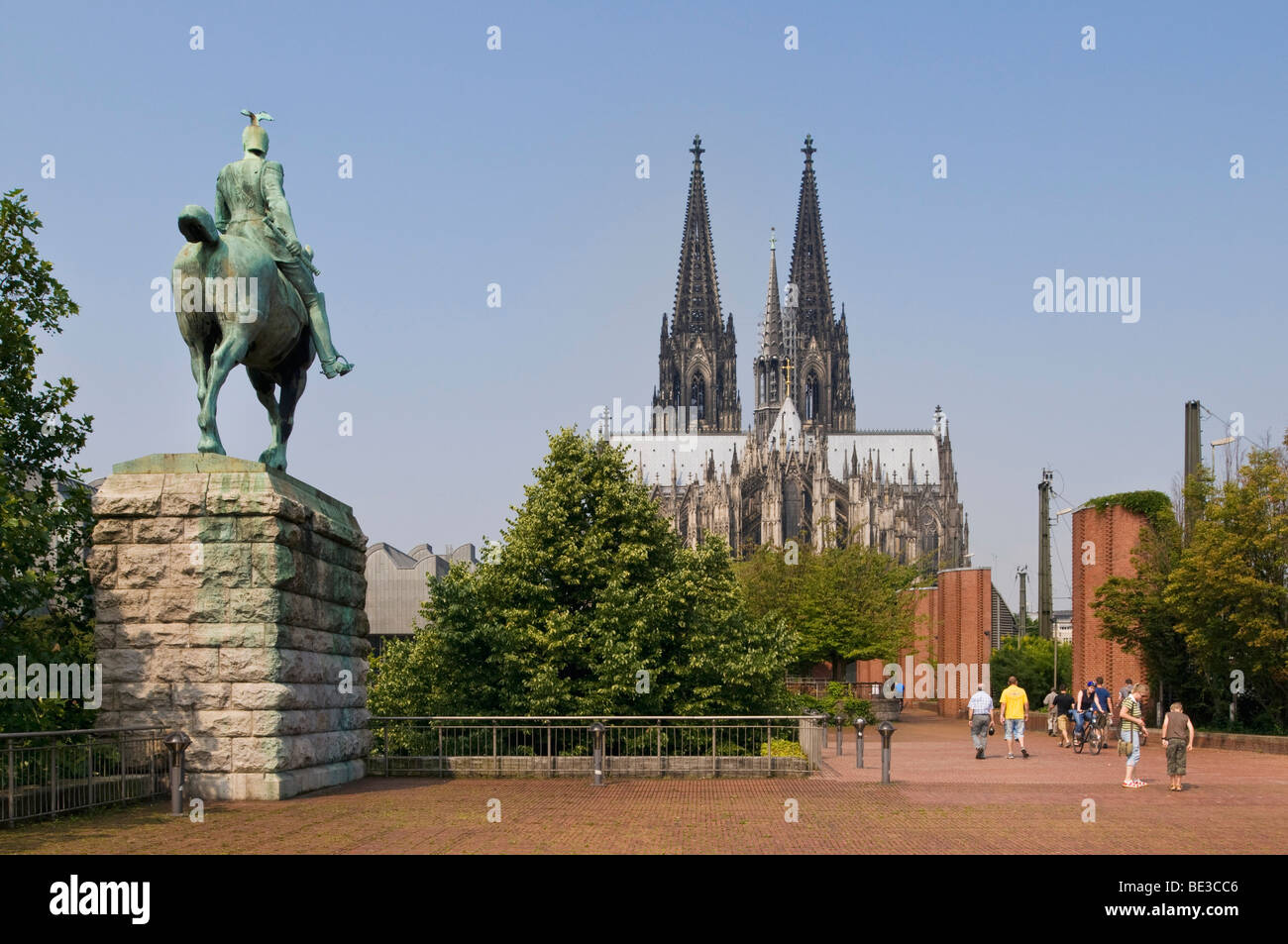 Equestrian statue of the Emperor Wilhelm II of Prussia, at the Hohenzollernbruecke Bridge, cathedral in the back, Cologne, Nort Stock Photo