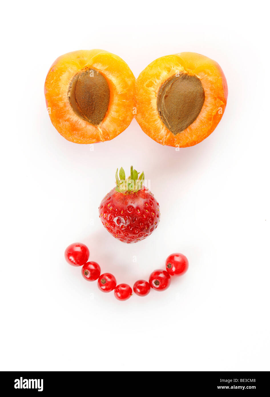 Face made of fruit, Apricots (Prunus armeniaca), Strawberries (Fragaria), Currants (Ribes) Stock Photo
