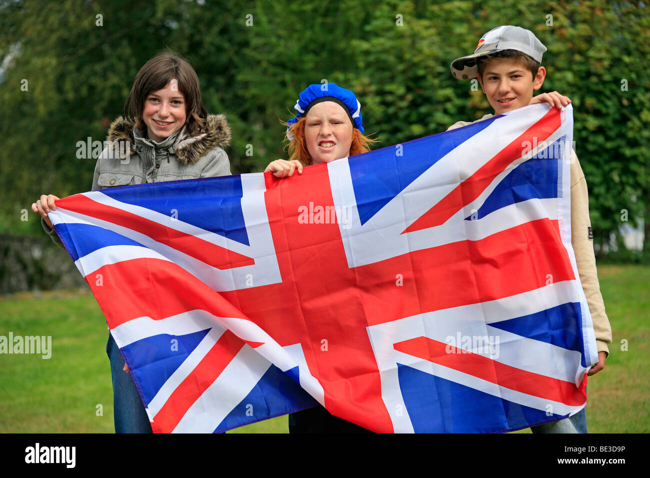 three kids holding the British flag, Scotland, Great Britain Stock Photo