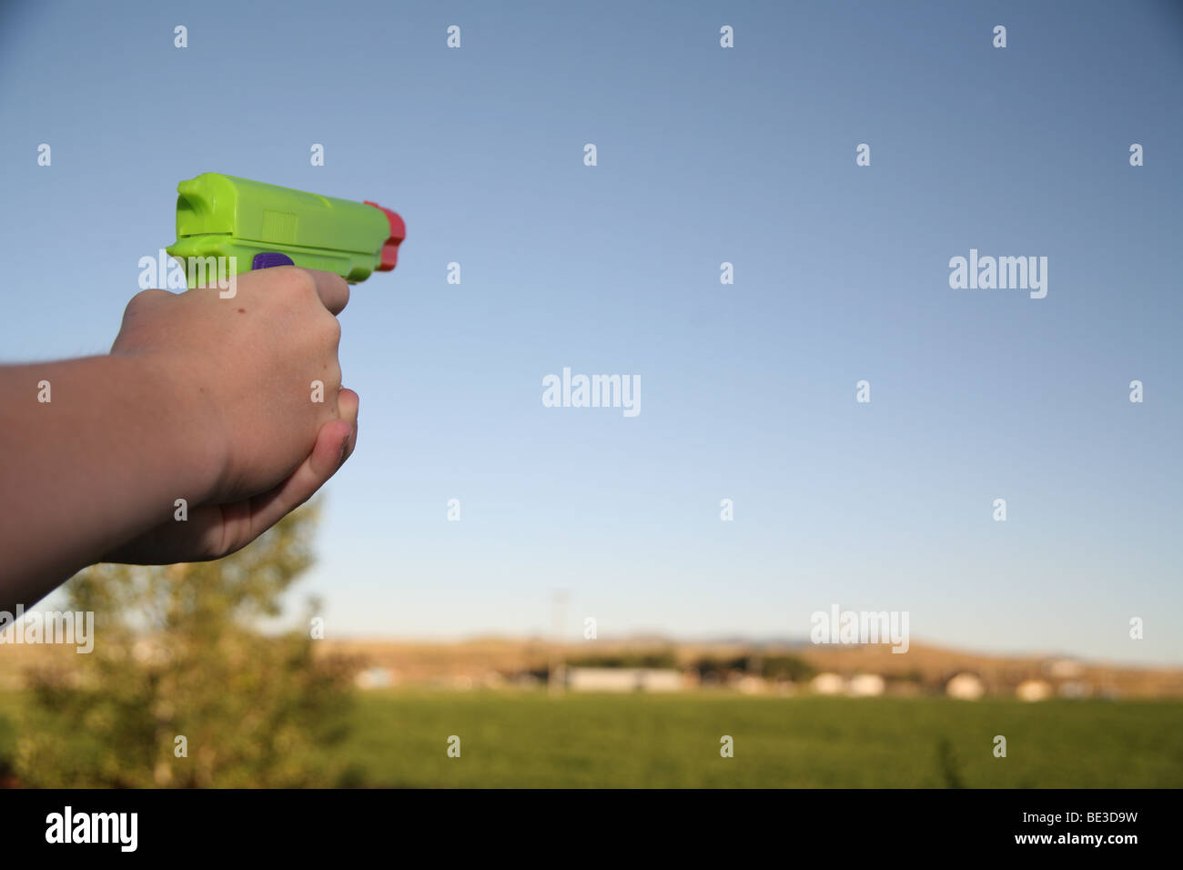 Hand holding water gun Stock Photo Alamy