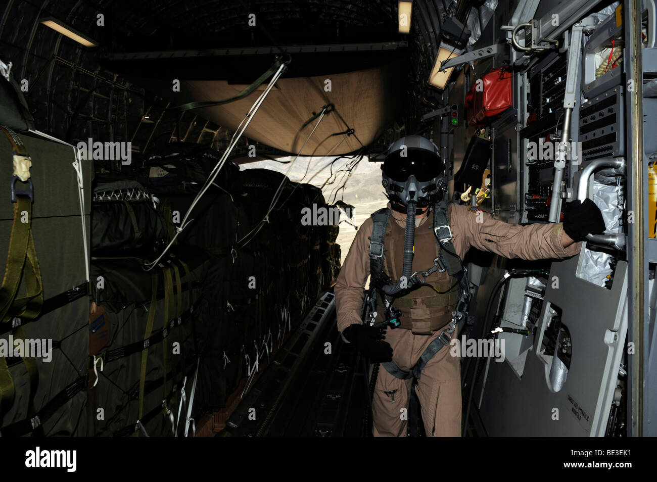 Container Delivery System bundles exit a C-17 Globemaster during an airdrop mission. Stock Photo