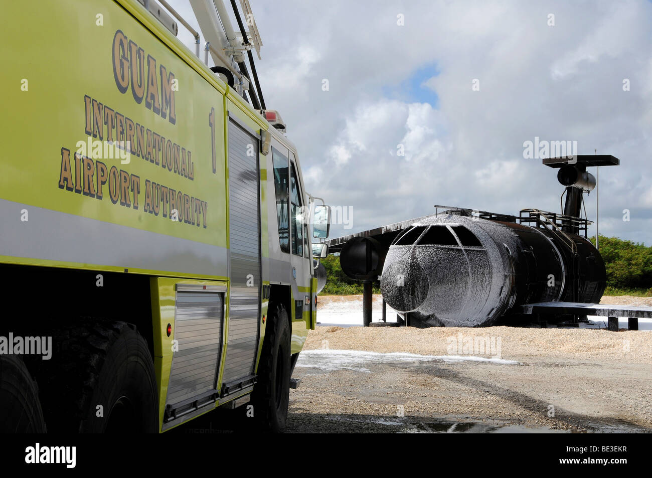 Guam's WONPAT Airport practices putting out a fire on the aircraft fire trainer. Stock Photo