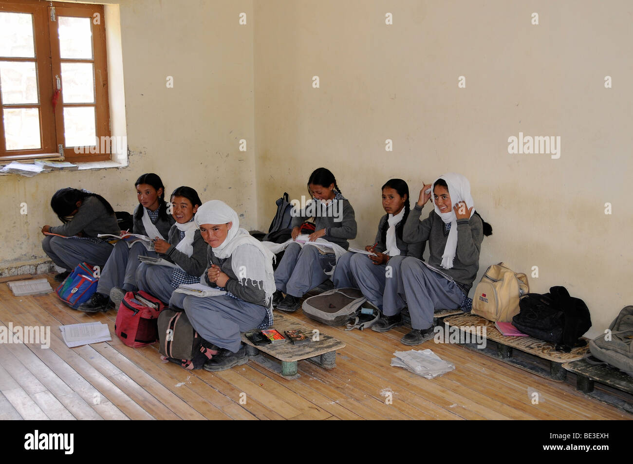 Students in uniform, on low benches in a class room, Phiyang, Ladakh, India, Himalayas, Asia Stock Photo