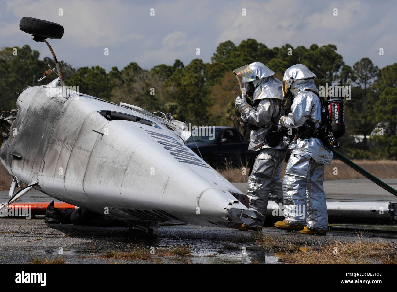 Firefighters respond to the scene of a simulated plane crash. Stock Photo