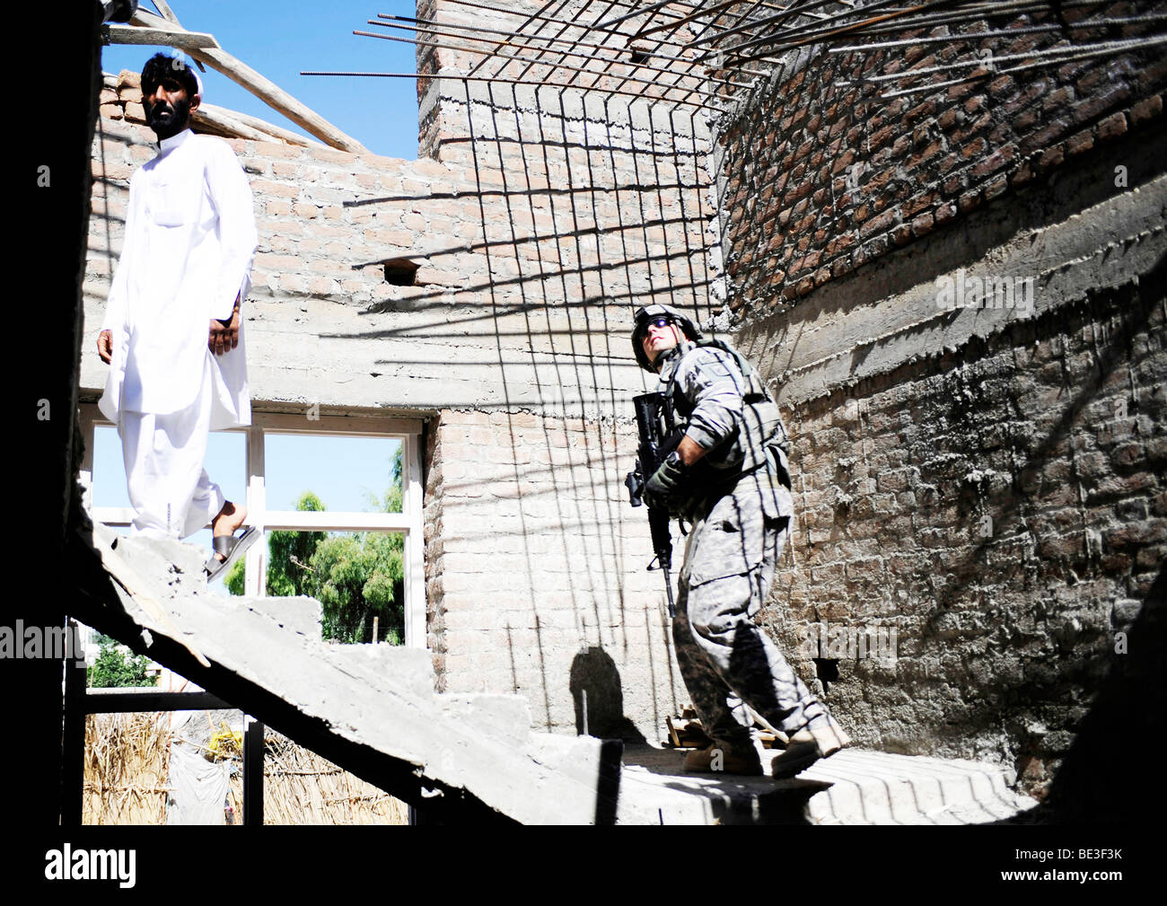 An engineer conducts a quality assurance inspection of a development site in Afghanistan. Stock Photo