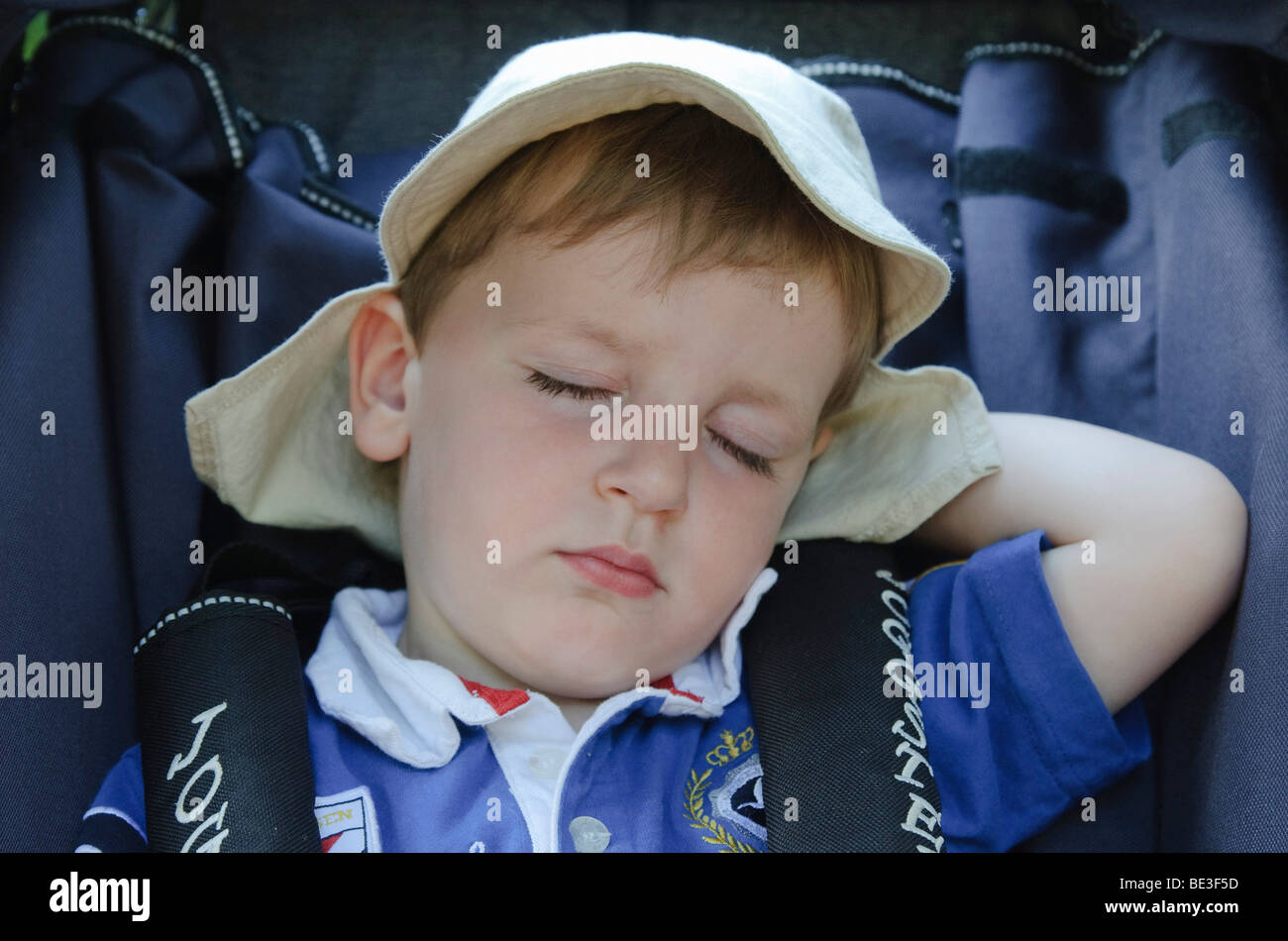 Young boy, 2 years old, sleeping in a pram Stock Photo Alamy