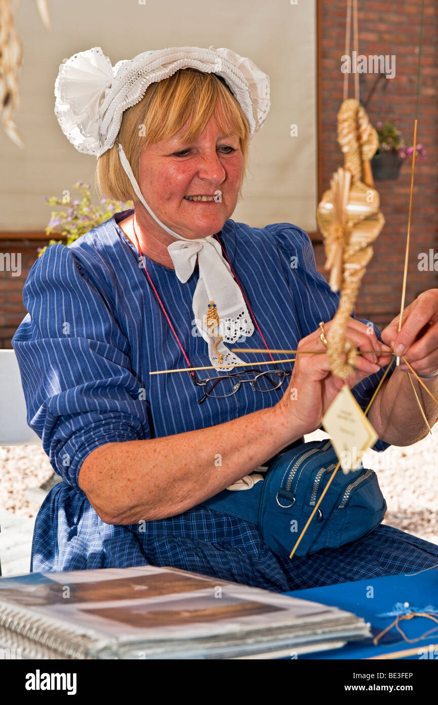 A lady making Corn Dollies Stock Photo