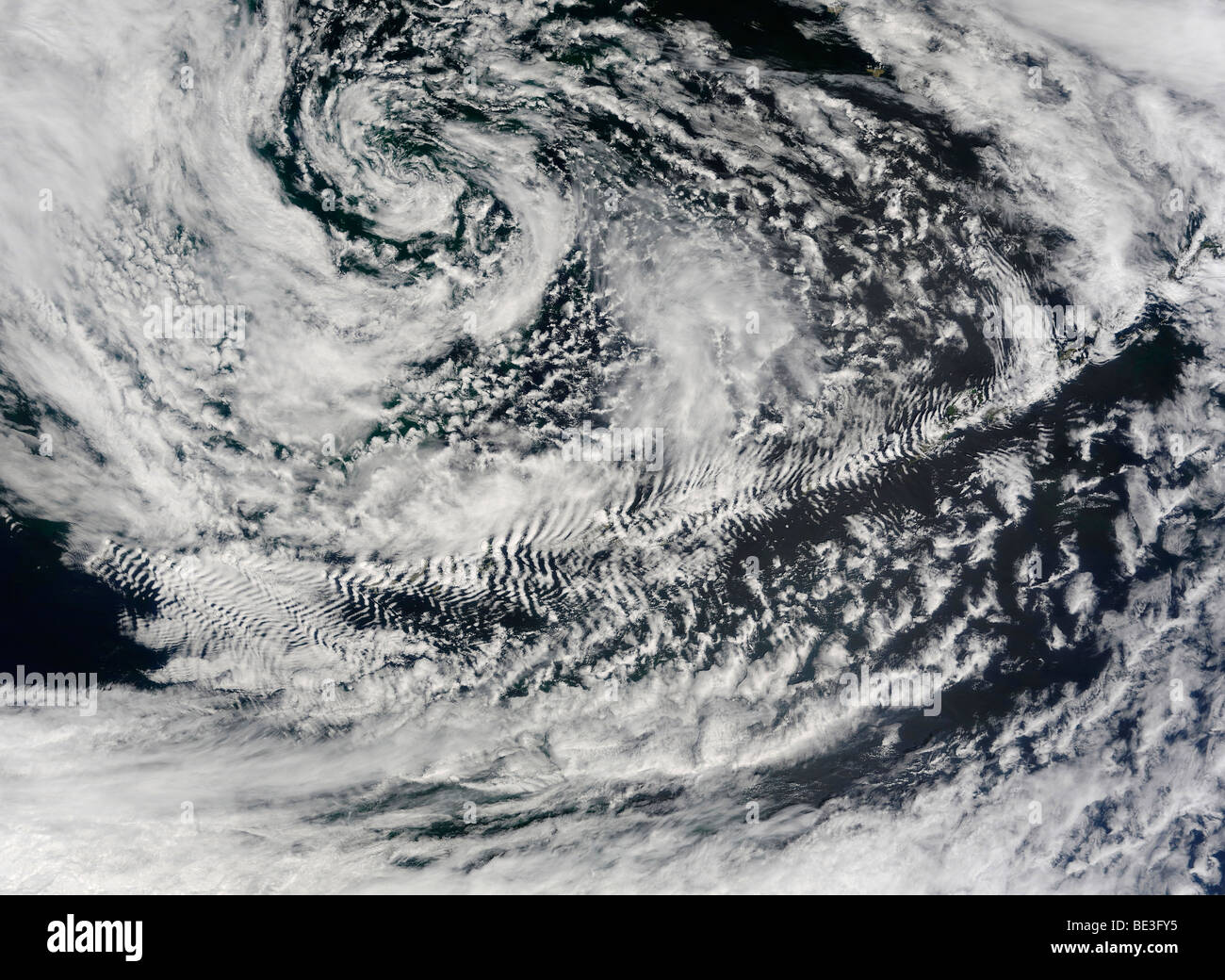 Ship-wave-shaped wave clouds induced by Aleutian Islands. Stock Photo