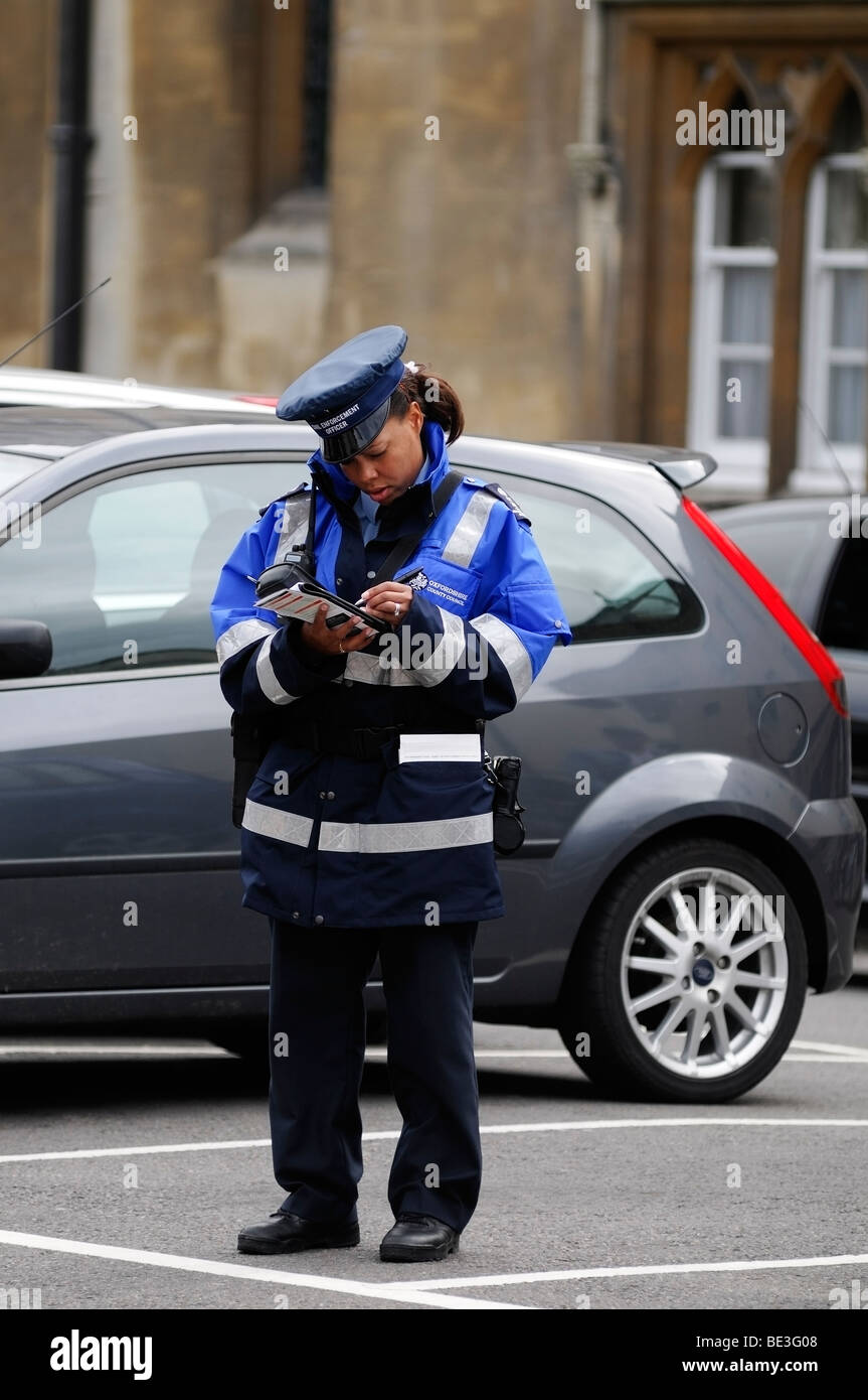 Traffic Warden Writing a Ticket, Oxford, England, United Kingdom. Stock Photo