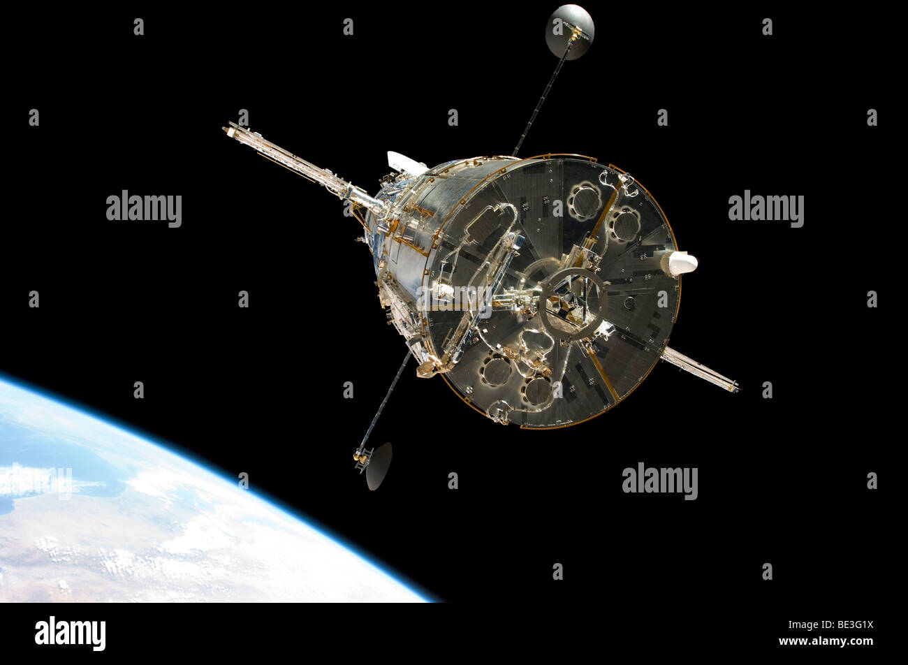 The Hubble Space Telescope in orbit above Earth. Stock Photo