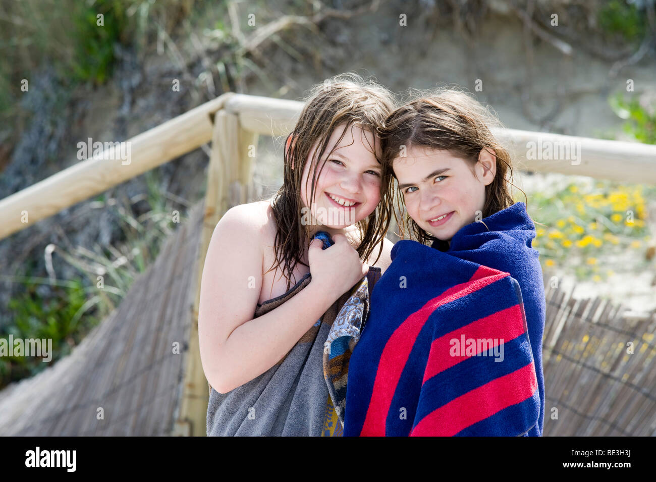 Girlfriends with bath towels, Stintino, Sardinia, Italy, Europe Stock Photo