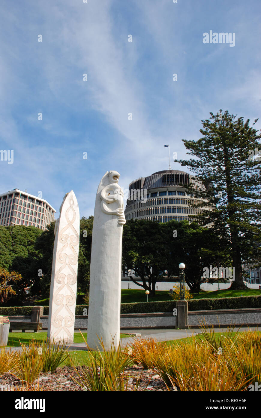 The Beehive is the home of the New Zealand Parliament, with Maori monument in foreground. Stock Photo