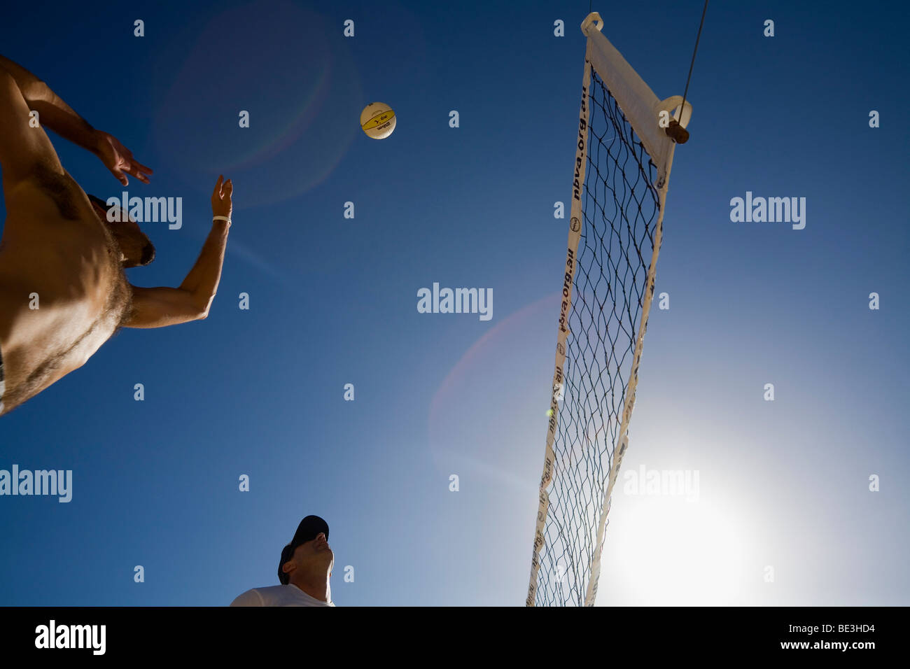 Man spiking a ball during a beach volleyball game. Manly Beach, Sydney