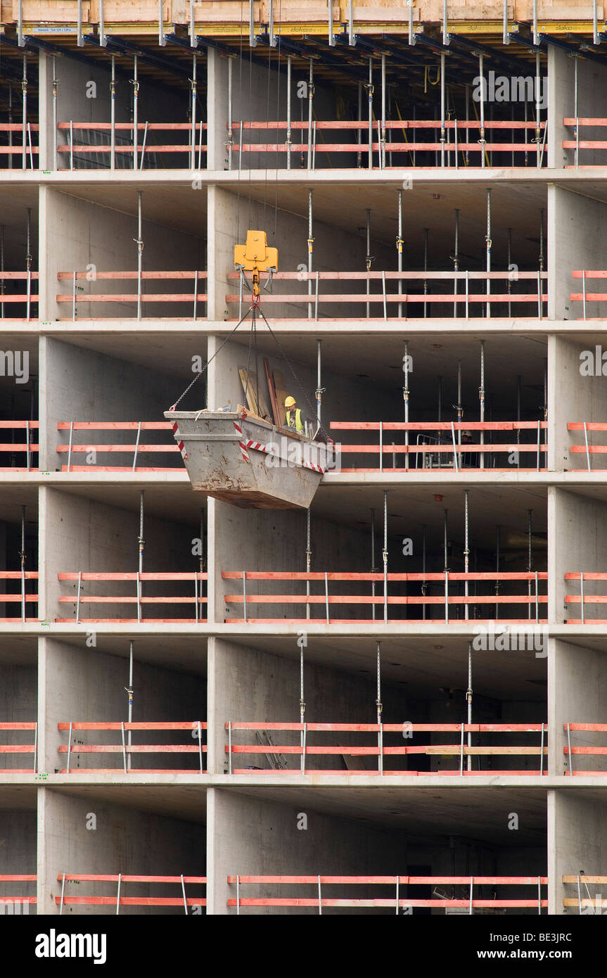 Large construction site, material containers hanging on a crane in ...