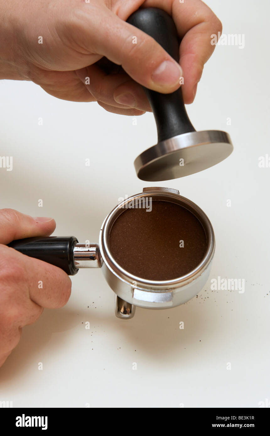 Professional preparation of espresso with an espresso machine: the grounds grounds are now perfectly even in the filter Stock Photo
