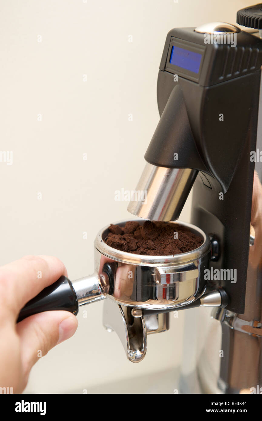 Professional preparation of espresso with an espresso machine Step 1 grinding espresso into