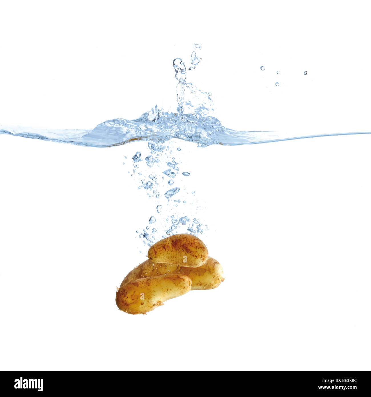 Potatoes in water Stock Photo Alamy