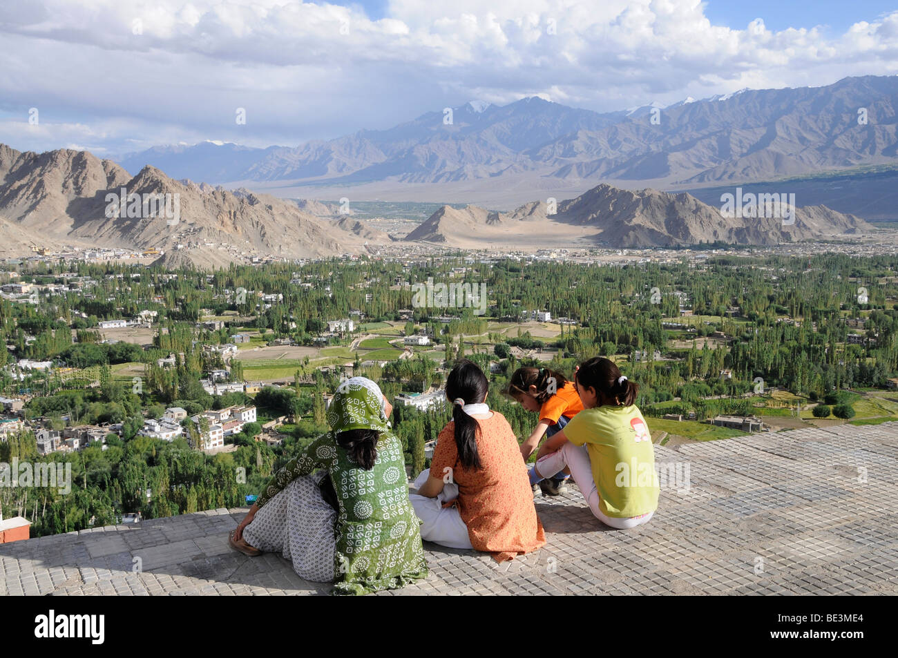 Ladakhi people looking from the Shanti Stupa on the oasis Leh, the Indus valley and the Zanskar mountain range, Ladakh, India,  Stock Photo