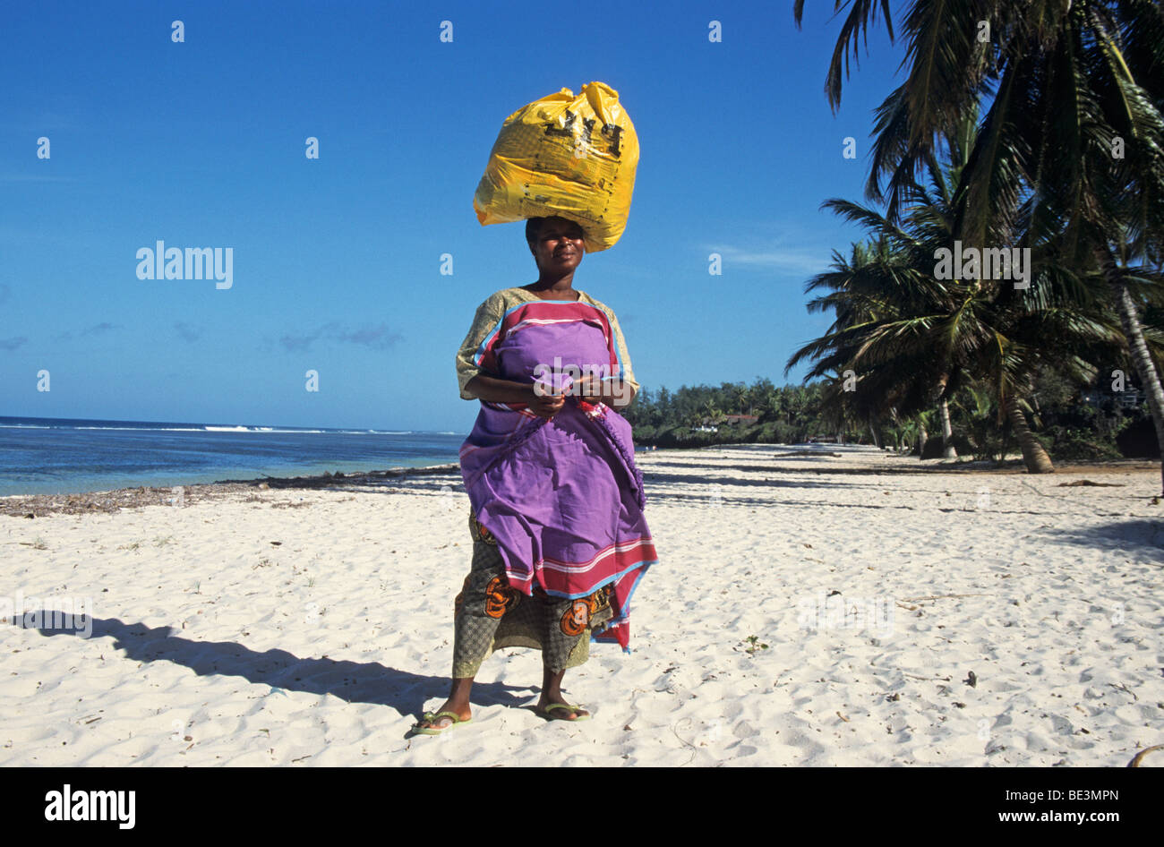 Top-heavy, woman carrying goods on her head, Kenya, Africa Stock Photo
