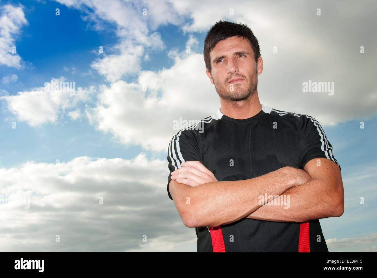 footballer standing with arms folded Stock Photo