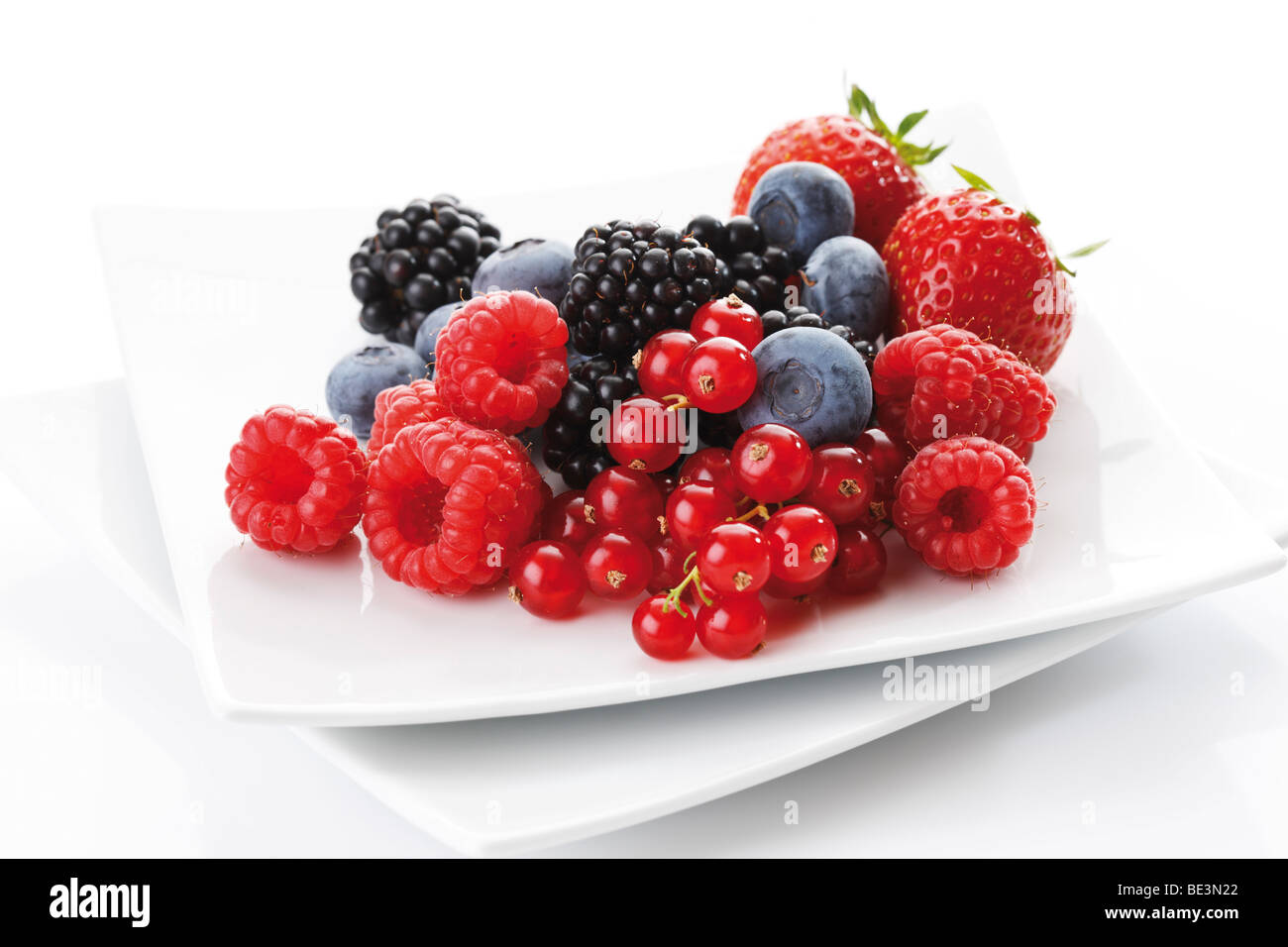 Wild berries on a plate, raspberries, blackberries, blueberries, strawberries Stock Photo