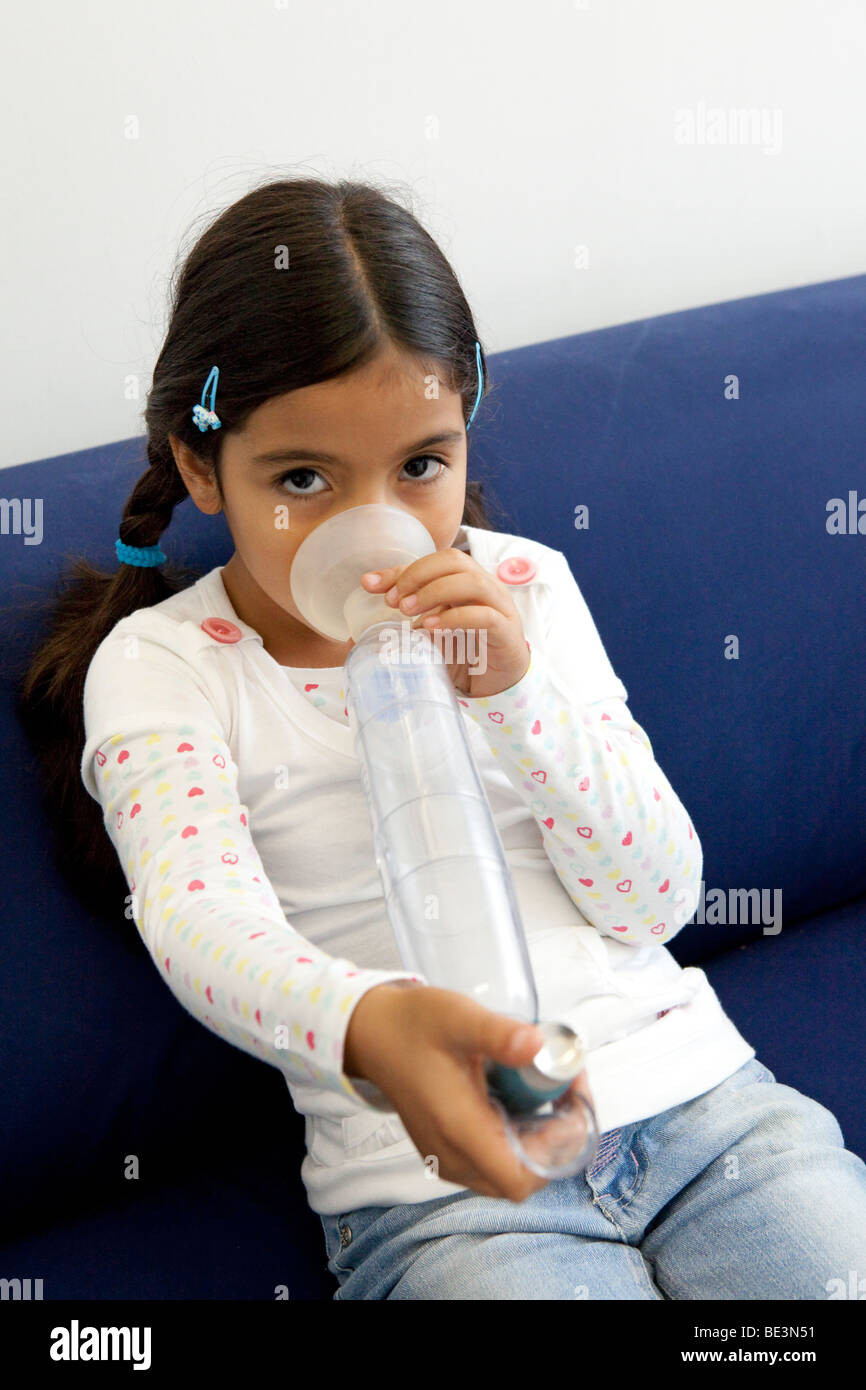 Little girl with an inhaler Stock Photo