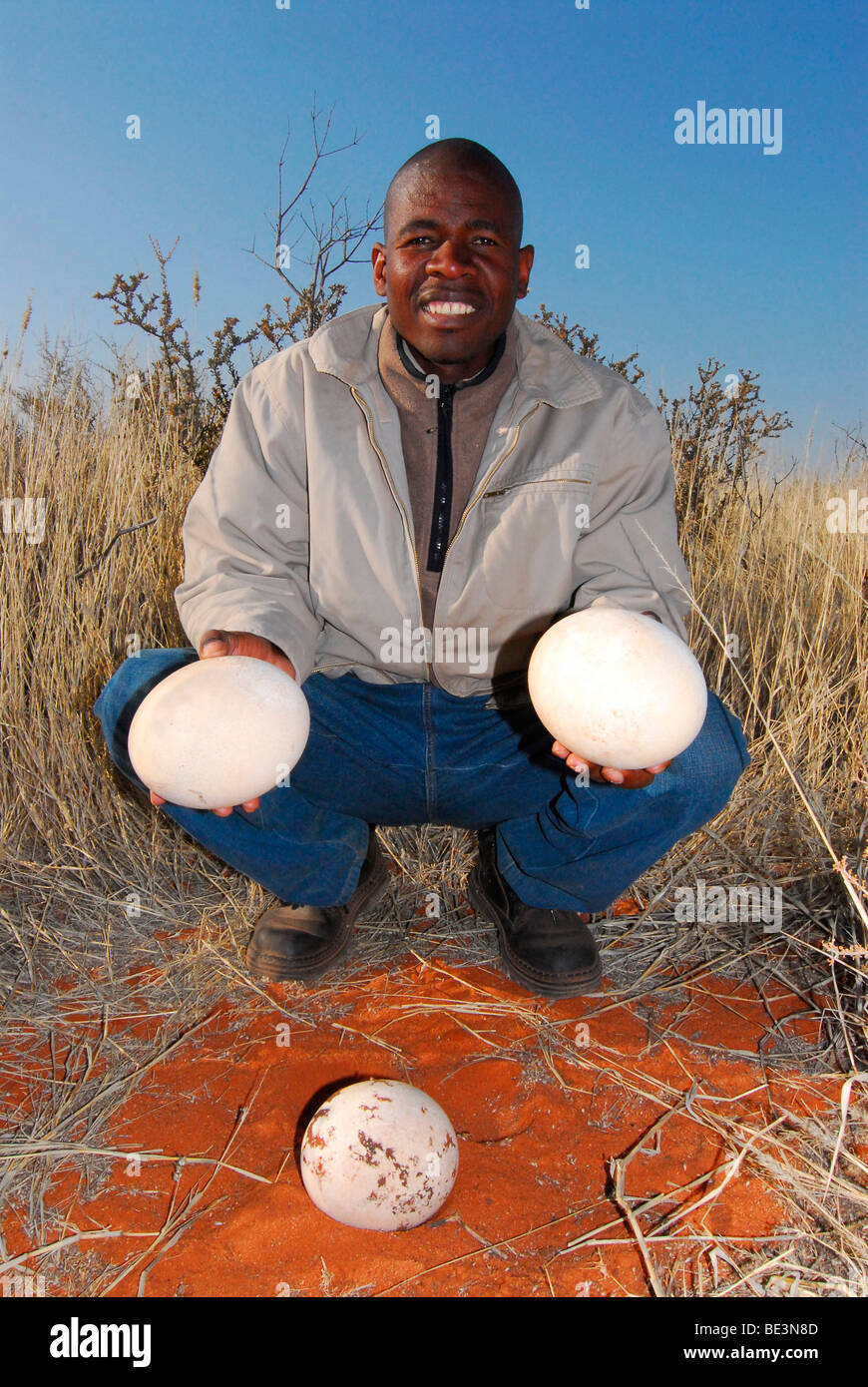 Native holding ostrich eggs on the grounds of the Kalahari Anib Lodge