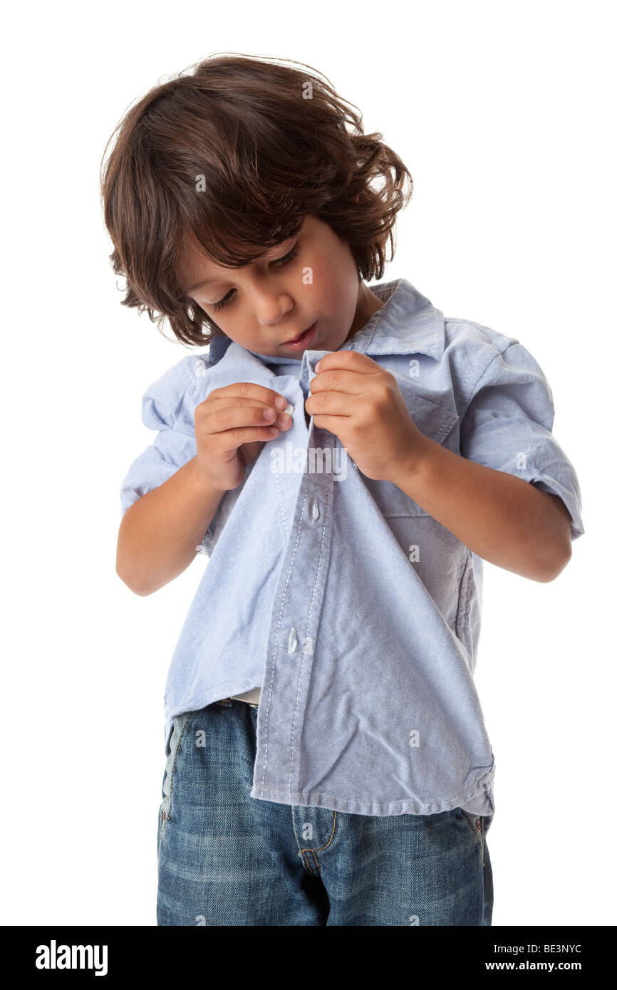 Little boy is buttoning shirt Stock Photo