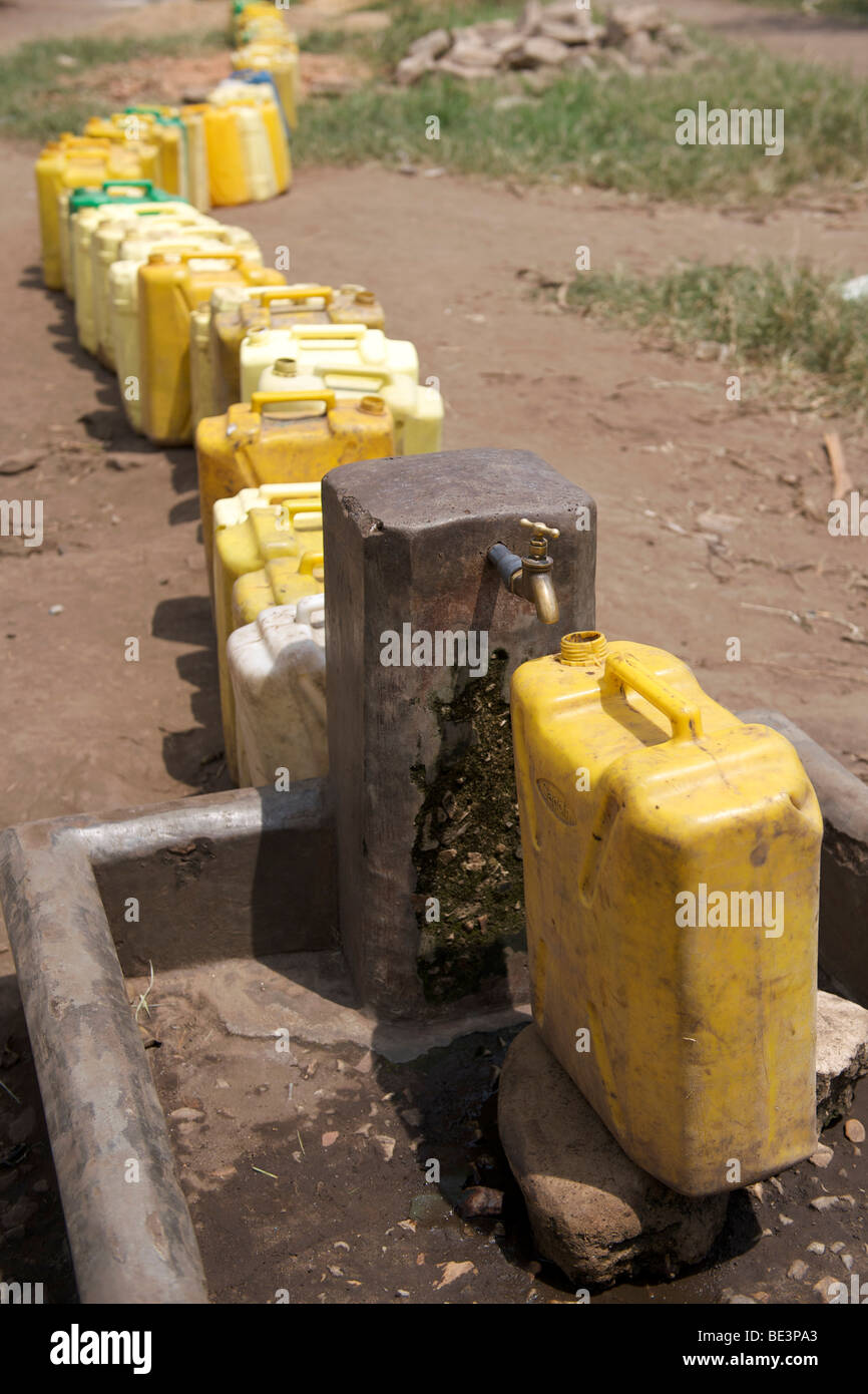 Plastic containers waiting to be filled at a tap in western Uganda Stock Photo Alamy
