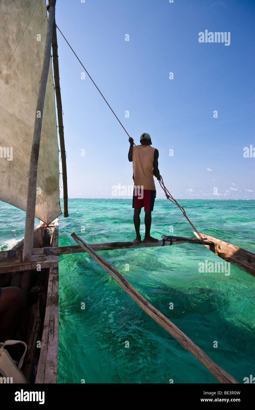 Arab dhow sailing in a blue lagoon, Zanzibar, Tanzania, Africa Stock Photo