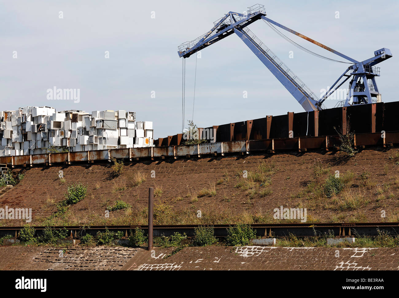 Large overhead crane handling scrap metal for recycling, discarded