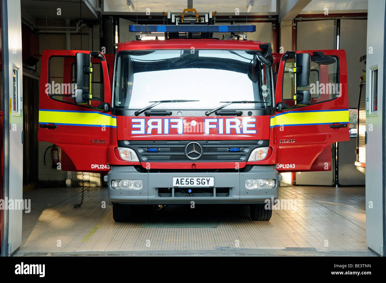 Fire Engine inside fire station with doors open London England UK Stock Photo