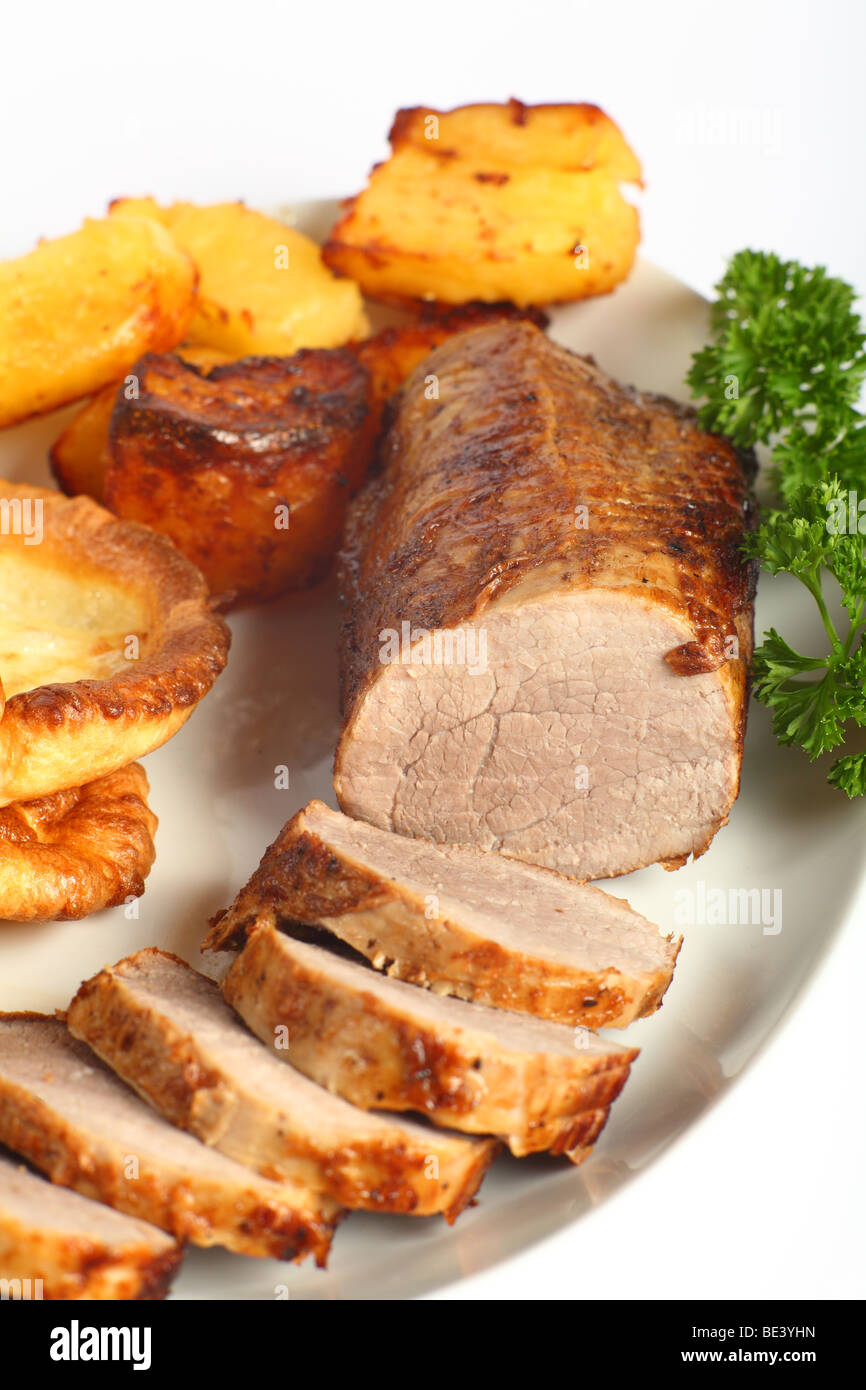 A beef "eye roast" joint, sliced into medallions, on a plate with roast