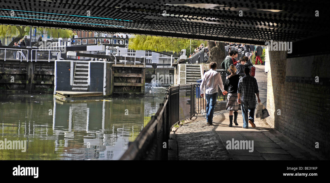 people walking under bridge over river a camden lock camden london united kingdom Stock Photo