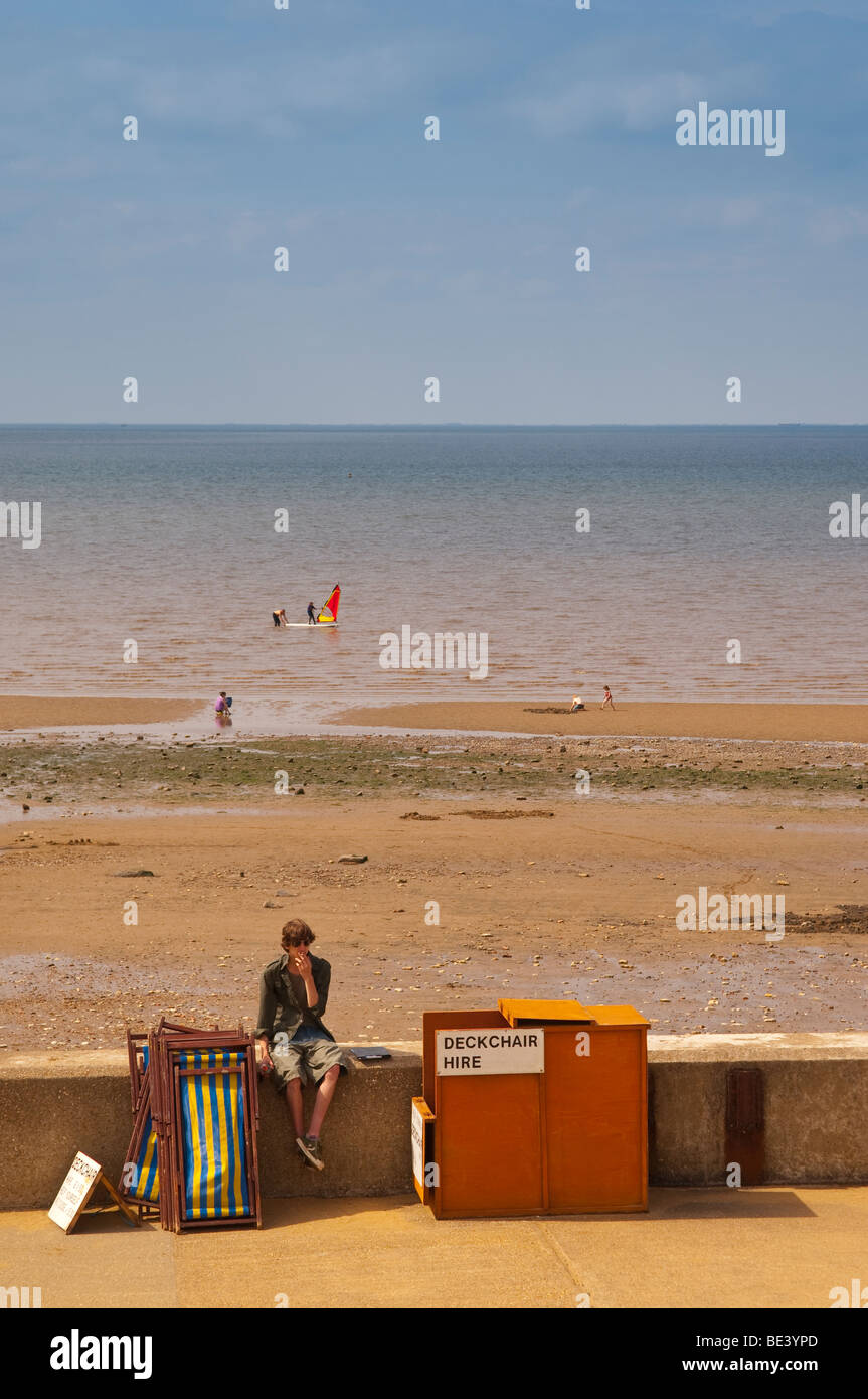 A man hiring deck chairs out on the beach in Hunstanton , North Norfolk , Uk Stock Photo
