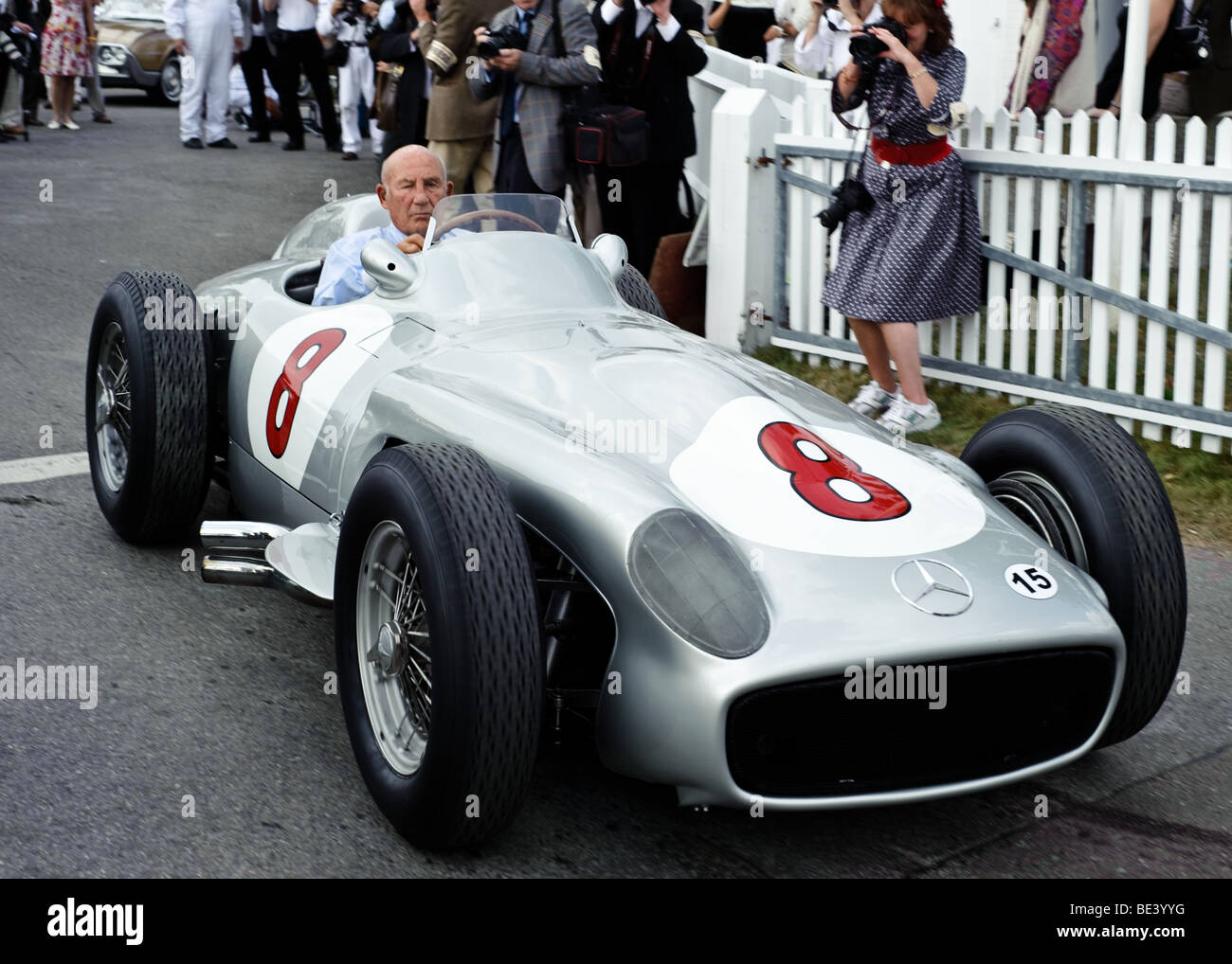 Sir Stirling Moss celebrates his 80th birthday driving a Mercedes Benz racing car on to the track at the Goodwood Revival Stock Photo