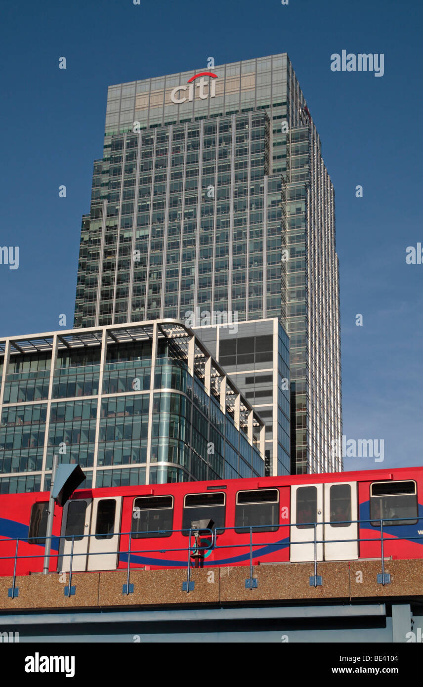 A Docklands Light Railway train passing in front of 25 Canada Square, Citibank Headquarters, London Docklands, UK. Stock Photo